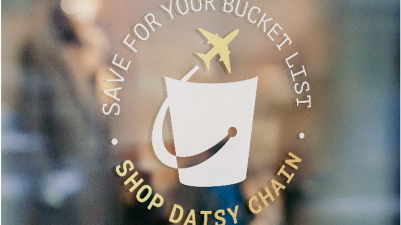 A sticker on a glass panel which says shop at Daisy Chain