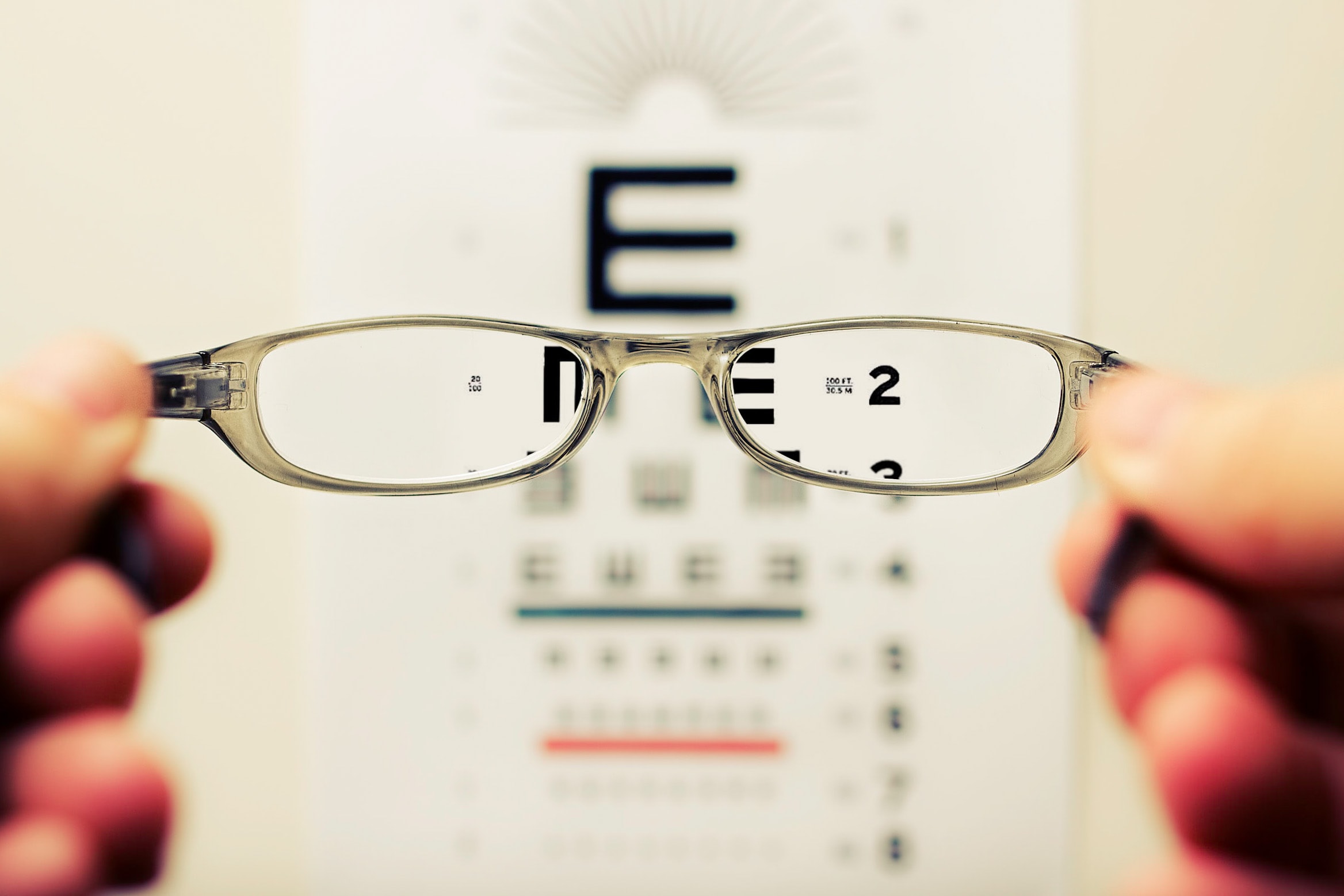 A photograph showing an optician's test through the lens of a pair of glasses