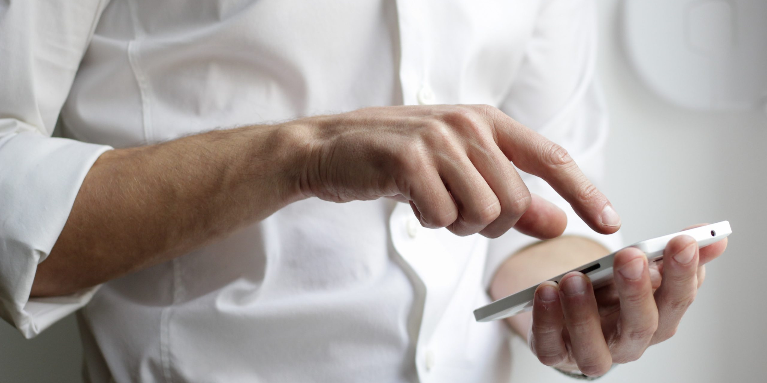 A man uses his mobile phone to look at a website