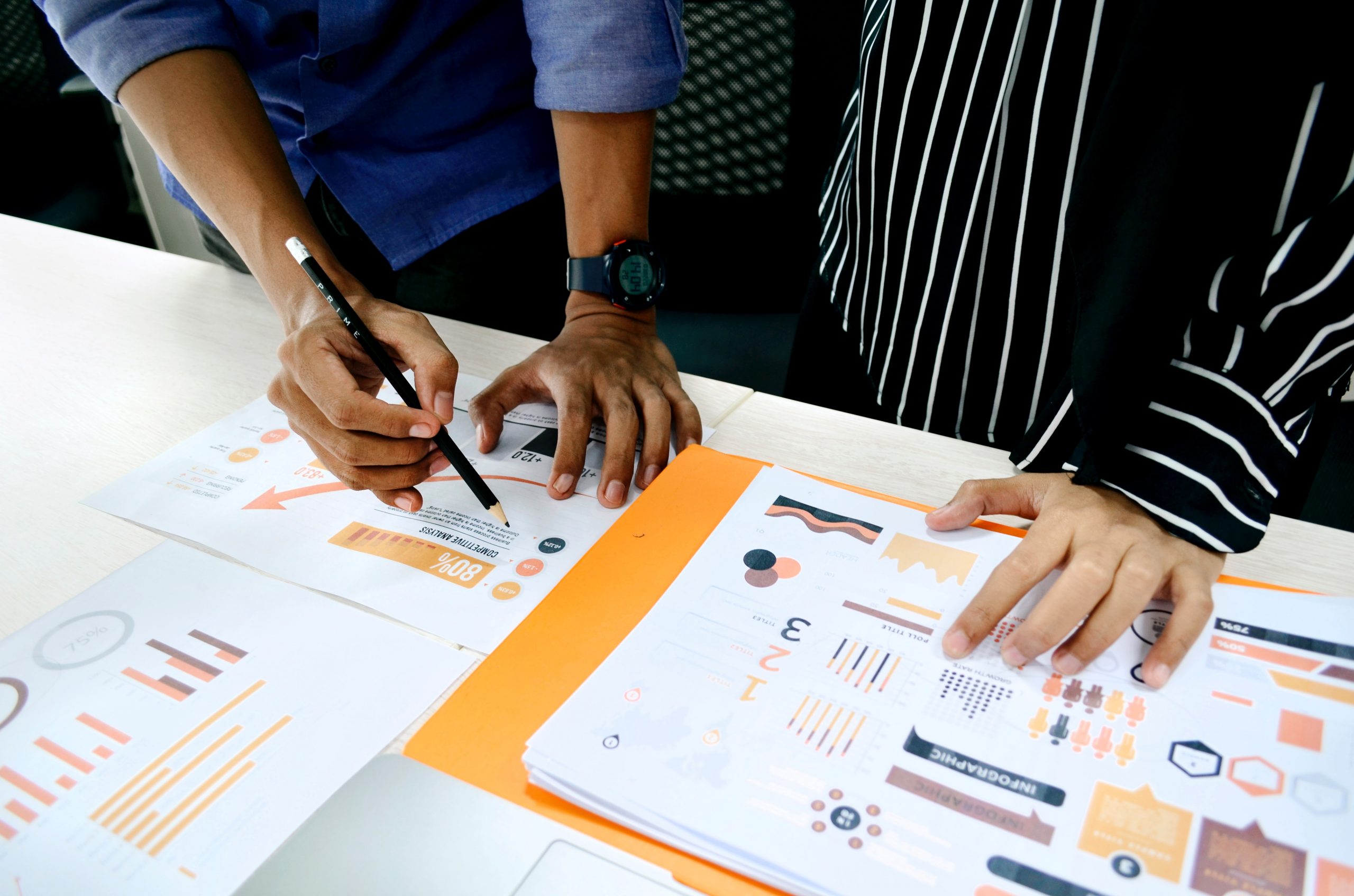A photograph of two people looking through website analytics on a table
