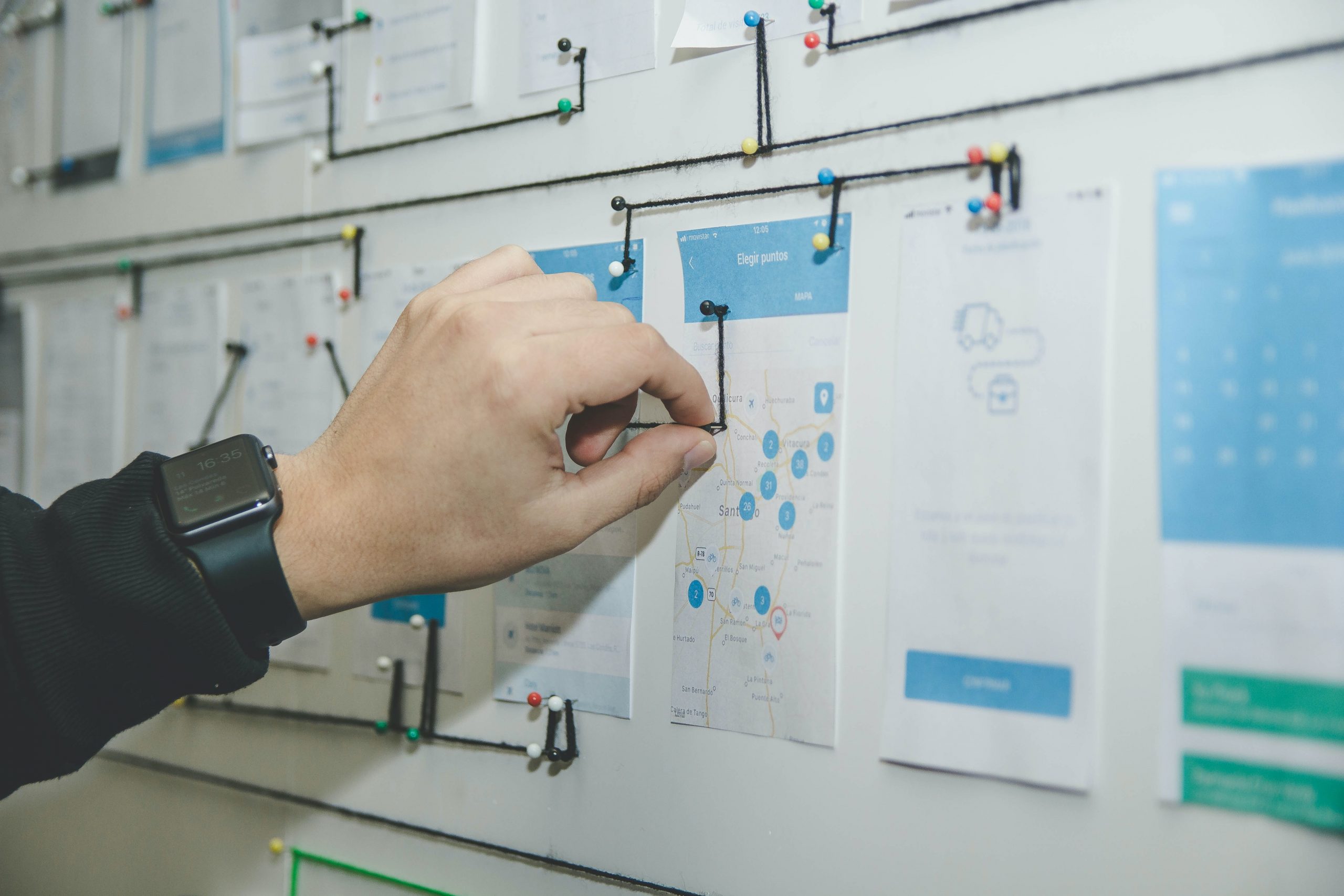 A photograph of an app designer planning out user experience on a whiteboard