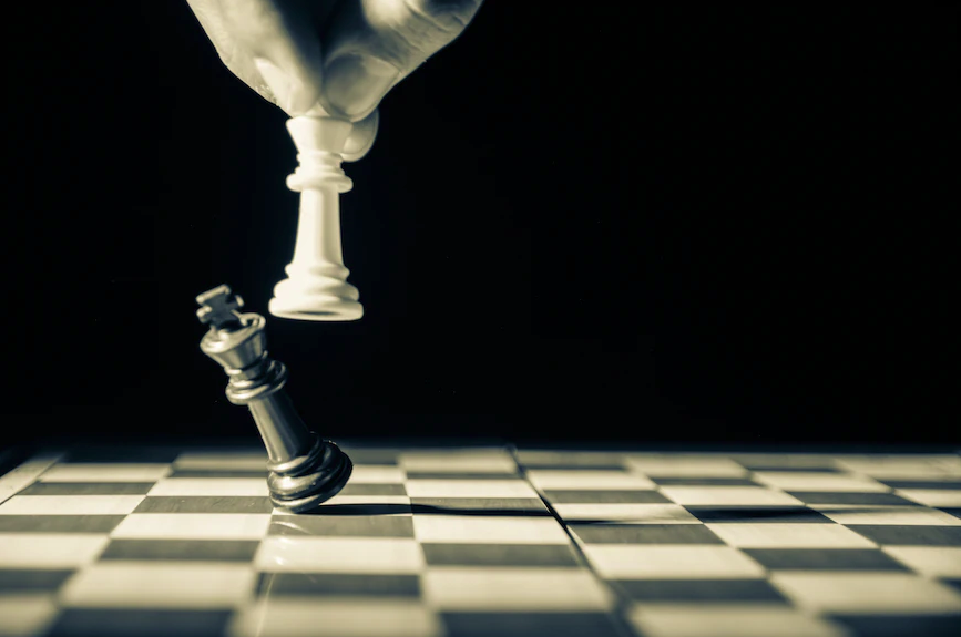 A black and white image of a chess victory