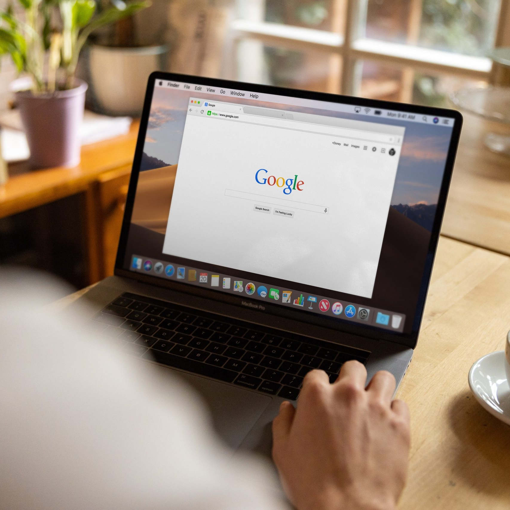A man on a laptop using Google Search